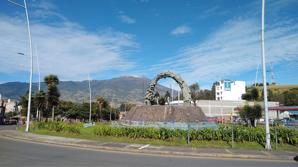 Amplia vista desde el monumento al campesino de fondo el volcán Galeras y un cielo azul parcialmente nublado.